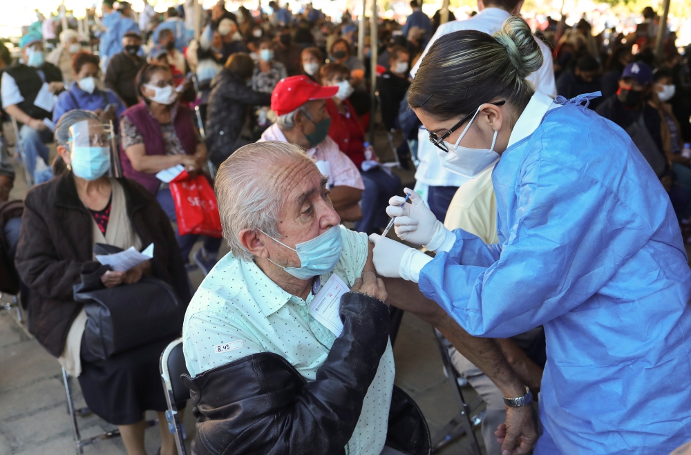 A man receives a dose of the Pfizer-BioNTech coronavirus disease (COVID-19) vaccine during a mass vaccination in Guadalajara, Mexico March 21, 2021. REUTERS/Henry Romero
