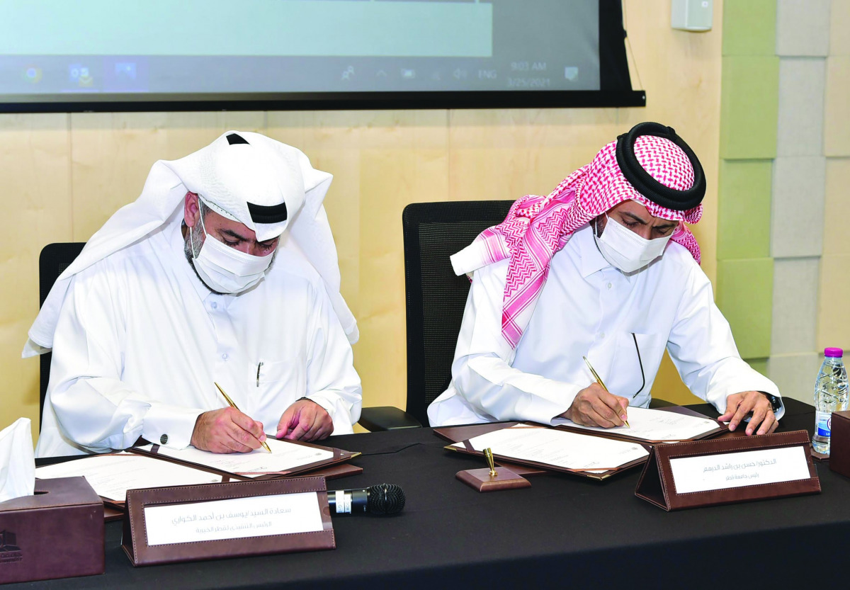 Dr. Hassan Al Derham (right), President of QU; and Yousef bin Ahmed Al Kuwari, CEO of Qatar Charity, signing the MoU. 