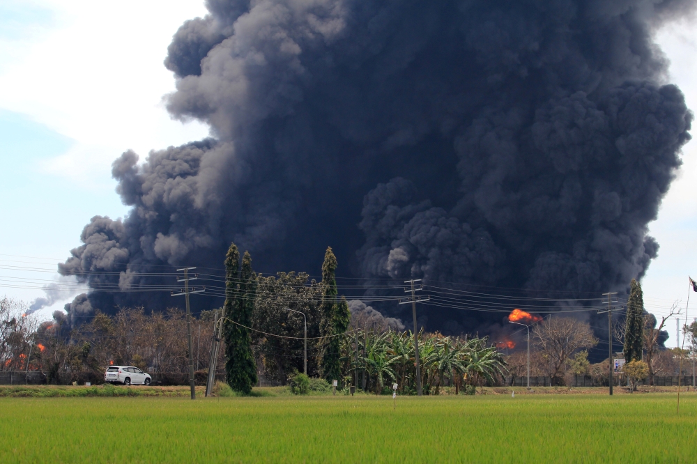 Smoke rises during a fire at Pertamina's oil refinery in Balongan, Indramayu regency, West Java province, Indonesia, March 29, 2021 in this photo taken by Antara Foto. Antara Foto/Dedhez Anggara/ via Reuters 
