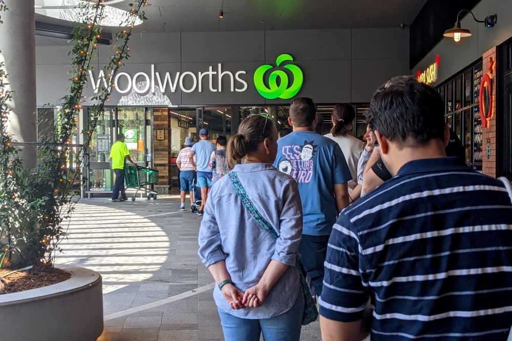 Shoppers line up outside a Woolworths store as greater Brisbane has been ordered into a snap three-day lockdown after four more cases of the coronavirus disease (COVID-19) emerged in the community, in Brisbane, Australia, March 29, 2021. AAP Image/Nick Gi