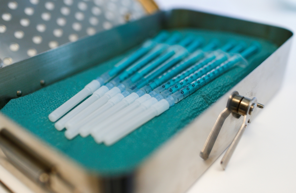 Syringes containing doses of the Pfizer-BioNTech coronavirus disease (COVID-19) vaccine are seen prepared to vaccinate patients at their homes in Cologne, Germany, March 28, 2021. Reuters/Thilo Schmuelgen