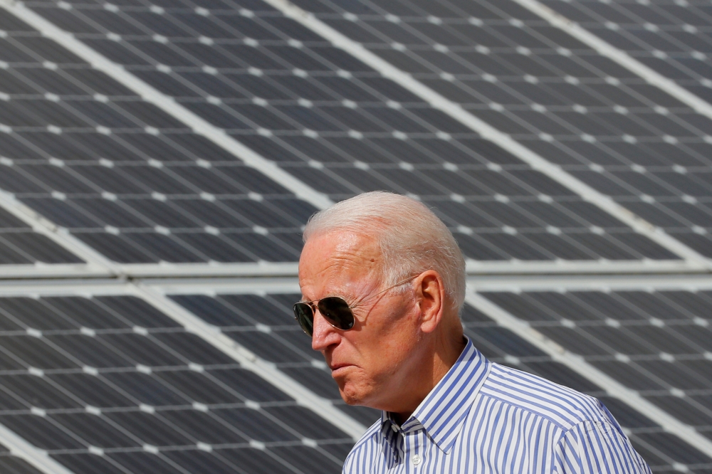 File photo: Democratic 2020 U.S. presidential candidate and former Vice President Joe Biden walks past solar panels while touring the Plymouth Area Renewable Energy Initiative in Plymouth, New Hampshire, U.S., June 4, 2019. Reuters/Brian Snyder/File Photo