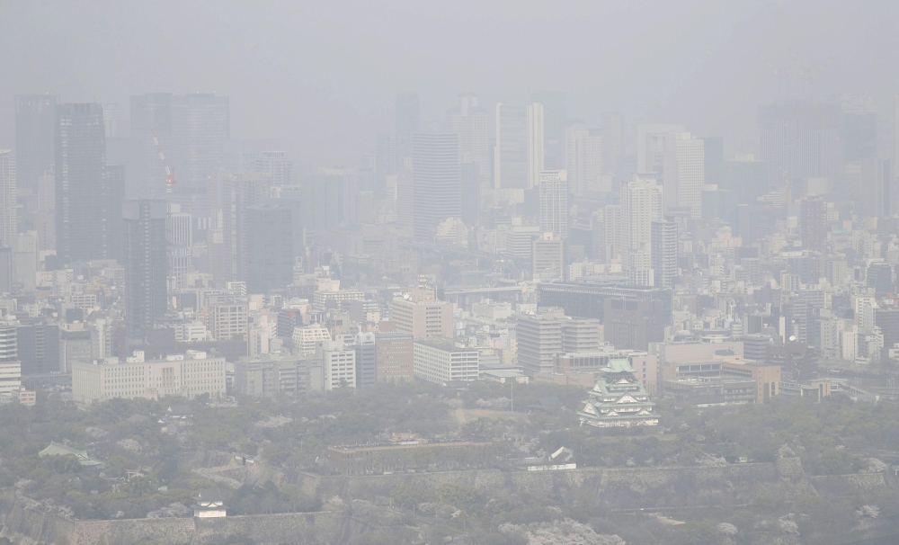 This aerial image taken from a Kyodo News helicopter shows the city of Osaka blanketed in a sandstorm, in this photo taken by Kyodo, Japan March 30, 2021. Kyodo/via Reuters