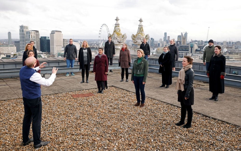 The choir of London's Royal Opera House perform on the rooftop of the Royal Opera House to celebrate Good Friday and the arrival of spring in London, Britain, March 25, 2021. Picture taken March 25, 2021. REUTERS/John Sibley