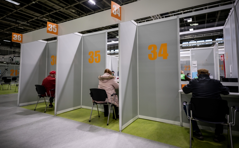 People register for the coronavirus disease (COVID-19) vaccination at the fairgrounds in Berlin, Germany, April 5, 2021. Michael Kappeler/Pool via REUTERS