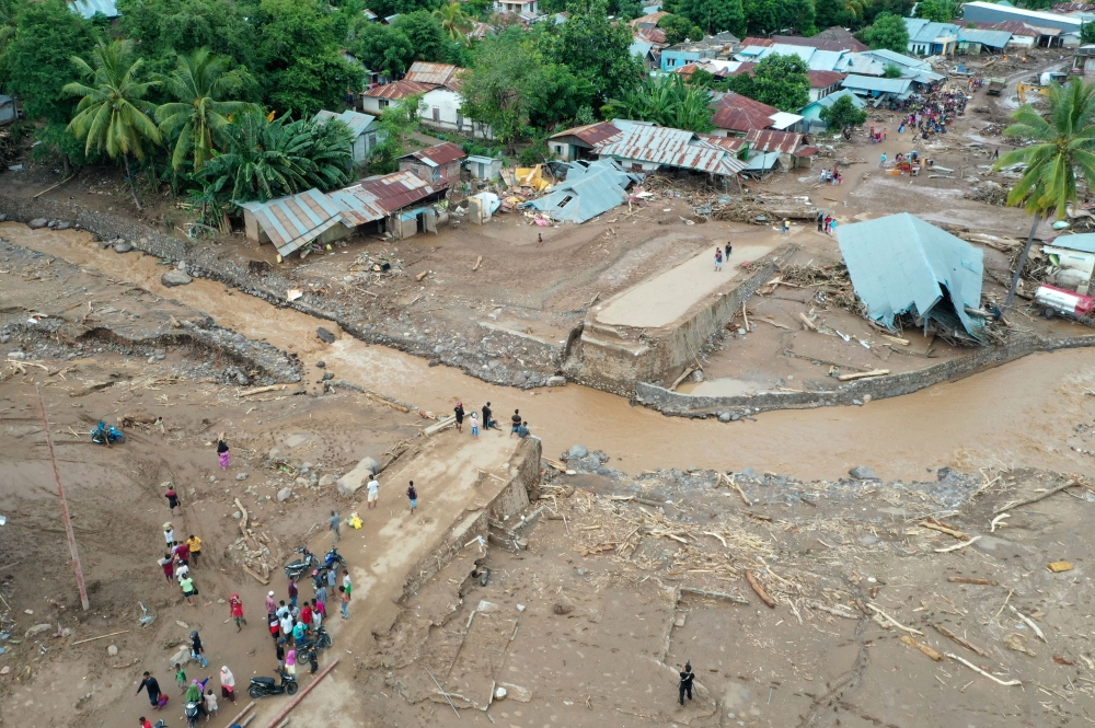 An aerial picture shows damaged roads affected by flash floods after heavy rains in East Flores, East Nusa Tenggara province, Indonesia April 6, 2021, in this photo taken by Antara Foto/Aditya Pradana Putra/via Reuters.