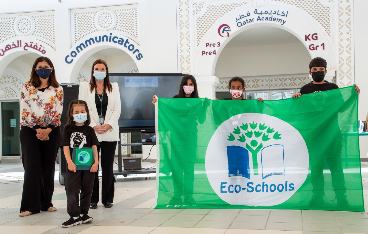 Qatar Academy Doha officials and students with the green flag.