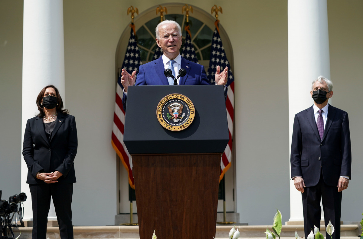 U.S. President Joe Biden is flanked by Vice President Kamala Harris and Attorney General Merrick Garland as he announces executive actions on gun violence prevention in the Rose Garden at the White House in Washington, U.S., April 8, 2021. REUTERS/Kevin L