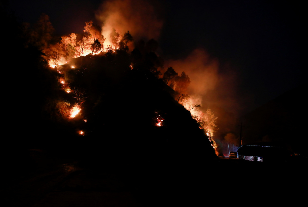 A hill burns during a forest fire in Makwanpur, outskirts of Kathmandu, as forest fires have raged many areas in Nepal contributing to worst air quality in the bowl shaped Kathmandu, Nepal April 8, 2021. REUTERS/Navesh Chitrakar
