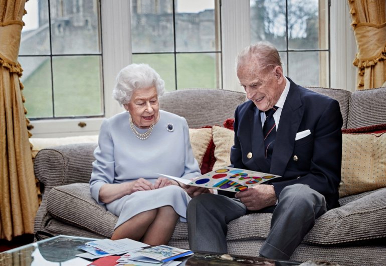 Britain's Queen Elizabeth and Prince Philip, Duke of Edinburgh look at their homemade wedding anniversary card, given to them by their great grandchildren Prince George, Princess Charlotte and Prince Louis, ahead of their 73rd wedding anniversary, in the 