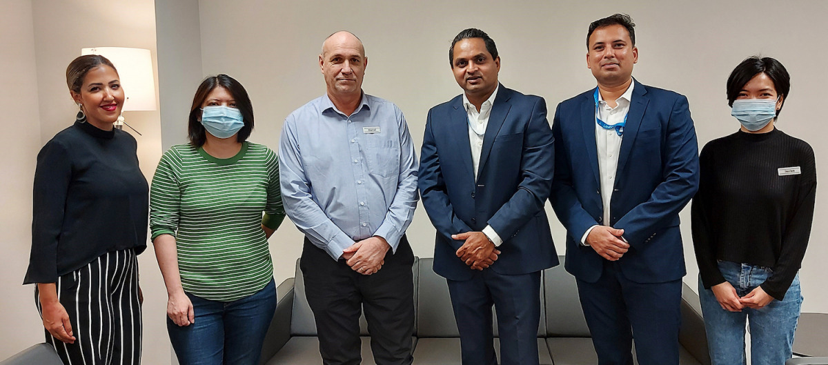 Officials of Doha Oasis Quest and Levtech Consulting pose for a group photo.
