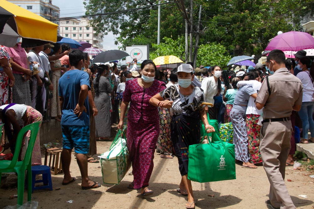 Relatives and friends wait outside the Insein Prison, as Myanmar's junta released 23,184 prisoners from jails across the country on Saturday under a New Year amnesty, in Yangon, Myanmar, April 17, 2021. REUTERS/Stringer