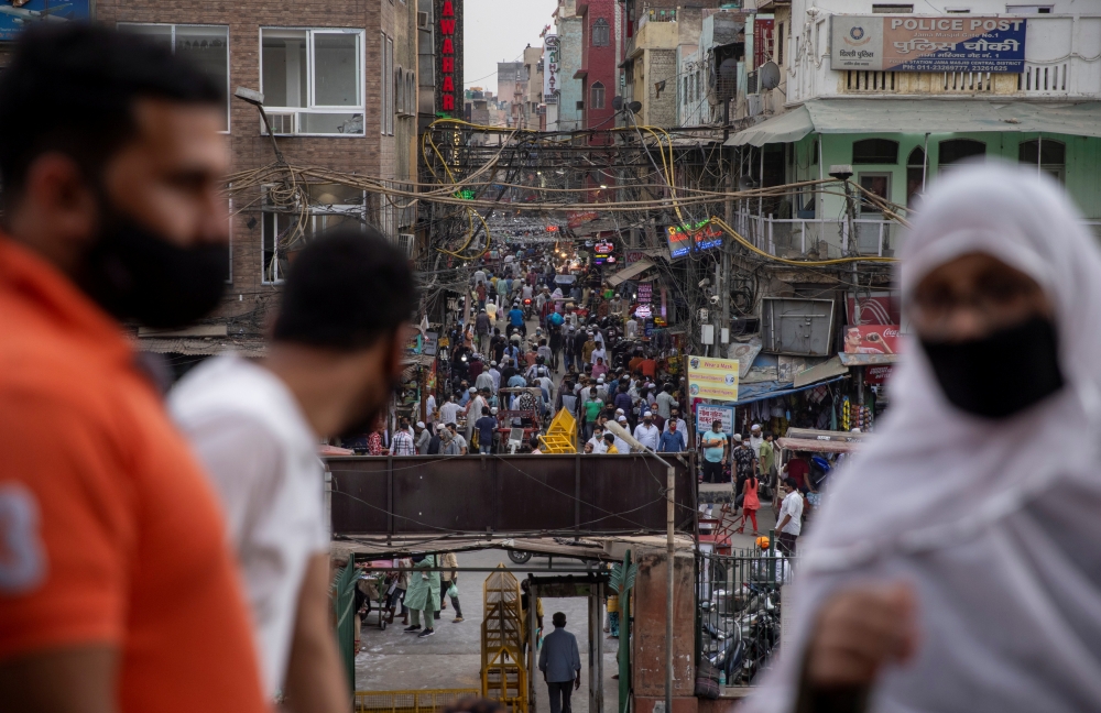 People are seen in a crowded marketplace amidst the spread of the coronavirus disease (COVID-19), in the old quarters of Delhi, India, April 14, 2021. REUTERS/Danish Siddiqui