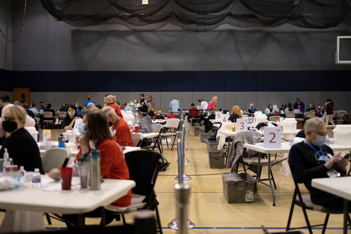 People receive the coronavirus disease (COVID-19) vaccine at a clinic ran by Skippack Pharmacy as cases rise in the state in Lansdale, Pennsylvania, U.S., April 18, 2021. REUTERS/Hannah Beier
