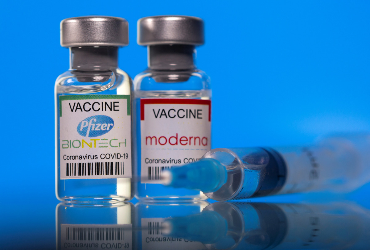 Vials with Pfizer-BioNTech and Moderna coronavirus disease (COVID-19) vaccine labels are seen in this illustration picture taken March 19, 2021. REUTERS/Dado Ruvic

