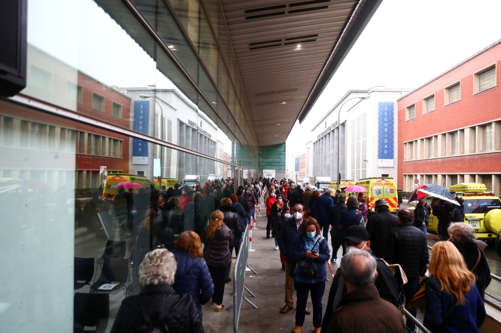 People queue to receive the AstraZeneca coronavirus disease (COVID-19) vaccine at a new mass vaccination centre in WiZink sports arena in Madrid, Spain, April 9, 2021. REUTERS/Sergio Perez/File Photo