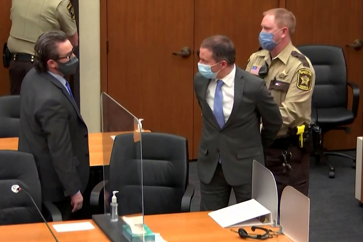 Former Minneapolis police officer Derek Chauvin is led away in handcuffs past his defense attorney Eric Nelson after a jury found him guilty of all charges in his trial for second-degree murder, third-degree murder and second-degree manslaughter in the de