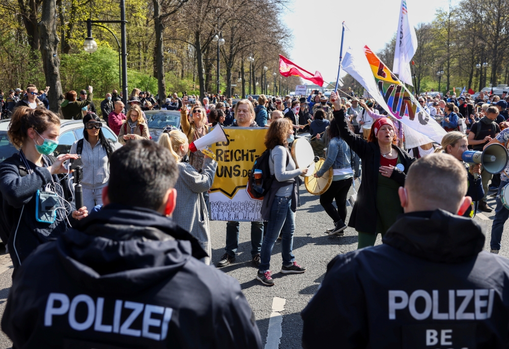 Members of the police stand guard as people protest against the government measures to curb the spread of the coronavirus disease (COVID-19), as the lower house of parliament Bundestag discusses additions for the Infection Protection Act, in Berlin, Germa