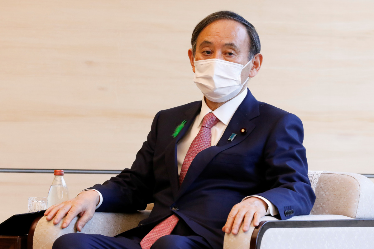 Japan's Prime Minister Yoshihide Suga wearing a face mask meets COP26 President Alok Sharma at the prime minister's official residence in Tokyo, Japan April 19, 2021. Rodrigo Reyes Marin/Pool via REUTERS
