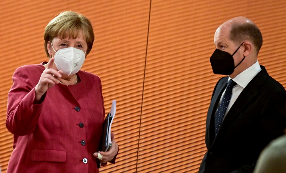 File photo: German Chancellor Angela Merkel and Finance Minister and Vice-Chancellor Olaf Scholz arrive for the weekly cabinet meeting at the Chancellery in Berlin, Germany April 21, 2021. Tobias Schwarz/Pool via Reuters/File Photo