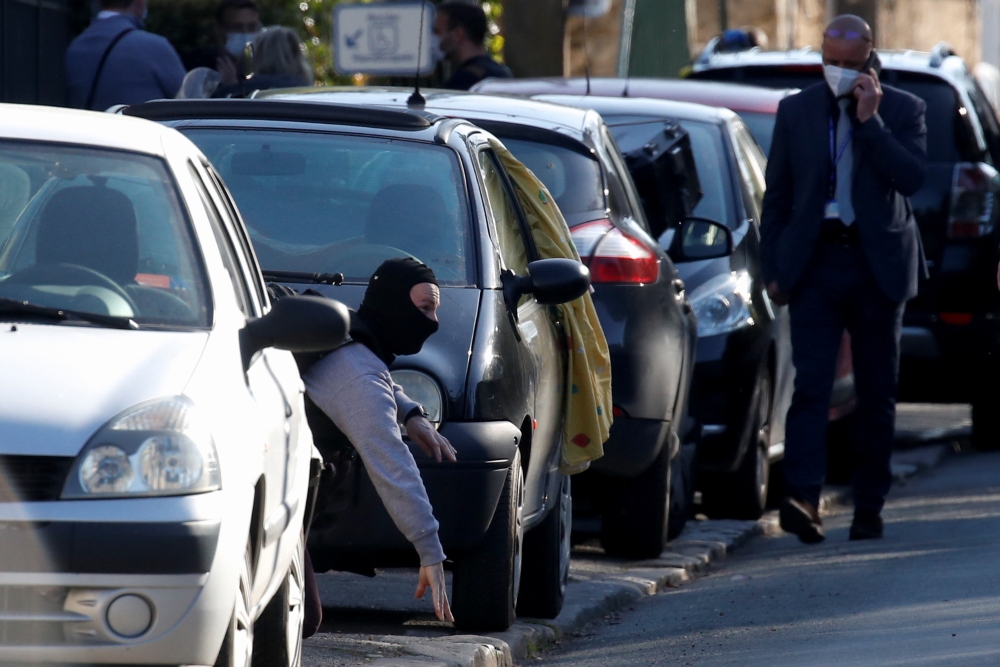 A police officer works in the area where an attacker stabbed a female police administrative worker, in Rambouillet, near Paris, France, April 23, 2021. Reuters/Gonzalo Fuentes