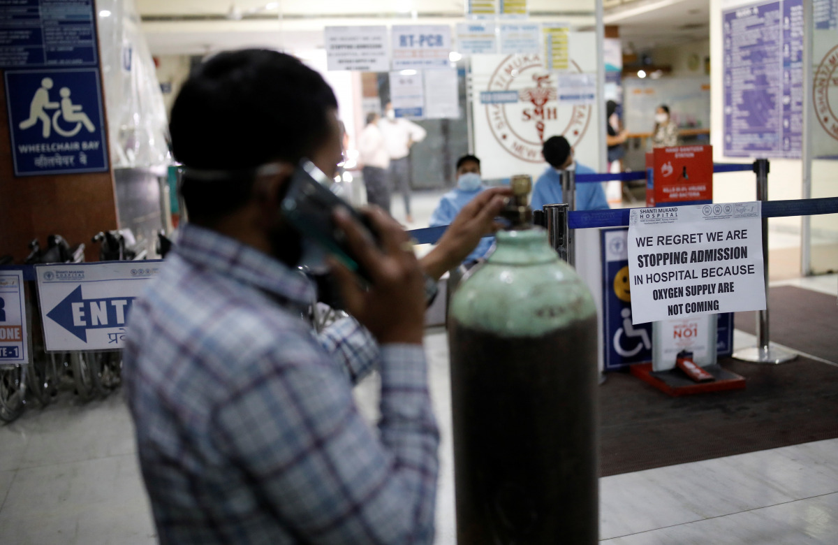 A man stands next to a notice outside a hospital, amidst the spread of the coronavirus disease (COVID-19) in New Delhi, India, April 22, 2021. Picture taken April 22, 2021. REUTERS/Adnan Abidi
