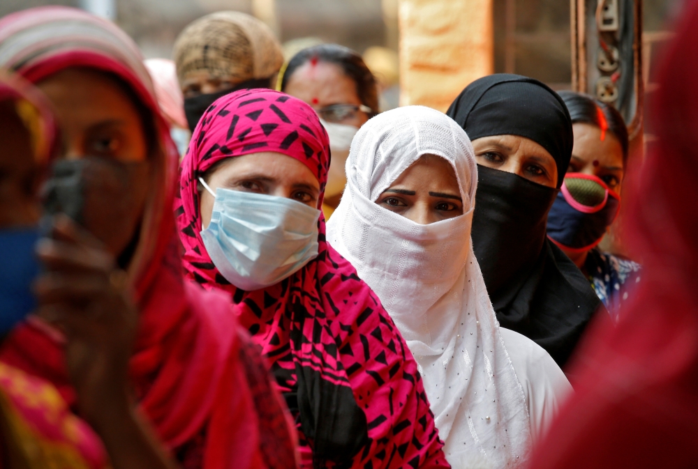 Women wait in line to cast their votes at a polling station during the seventh phase of West Bengal state election, amidst the spread of the coronavirus disease (COVID-19), in Kolkata, India, April 26, 2021. Reuters/Rupak De Chowdhuri
