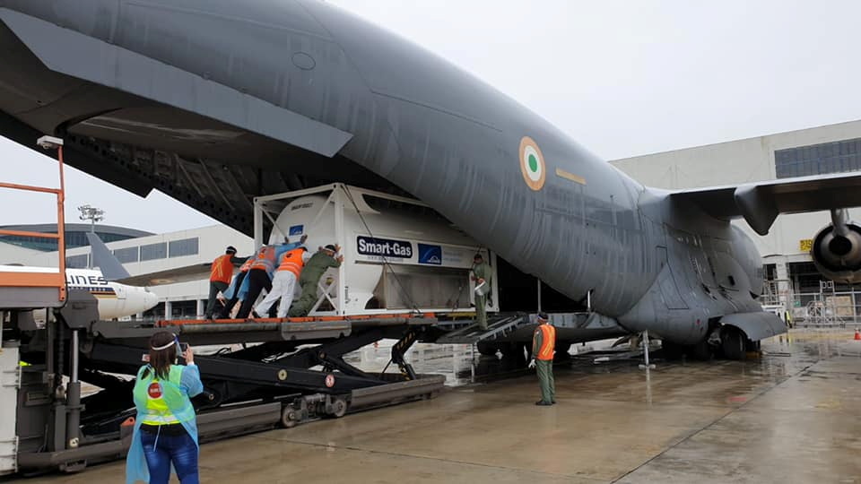 An oxygen tank is loaded into an aircraft to help hospitals in India running out of oxygen supplies amid coronavirus disease (COVID-19) outbreak, at the tarmac of Changi Airport in Singapore April 24, 2021 in this picture taken April 24, 2021 obtained fro