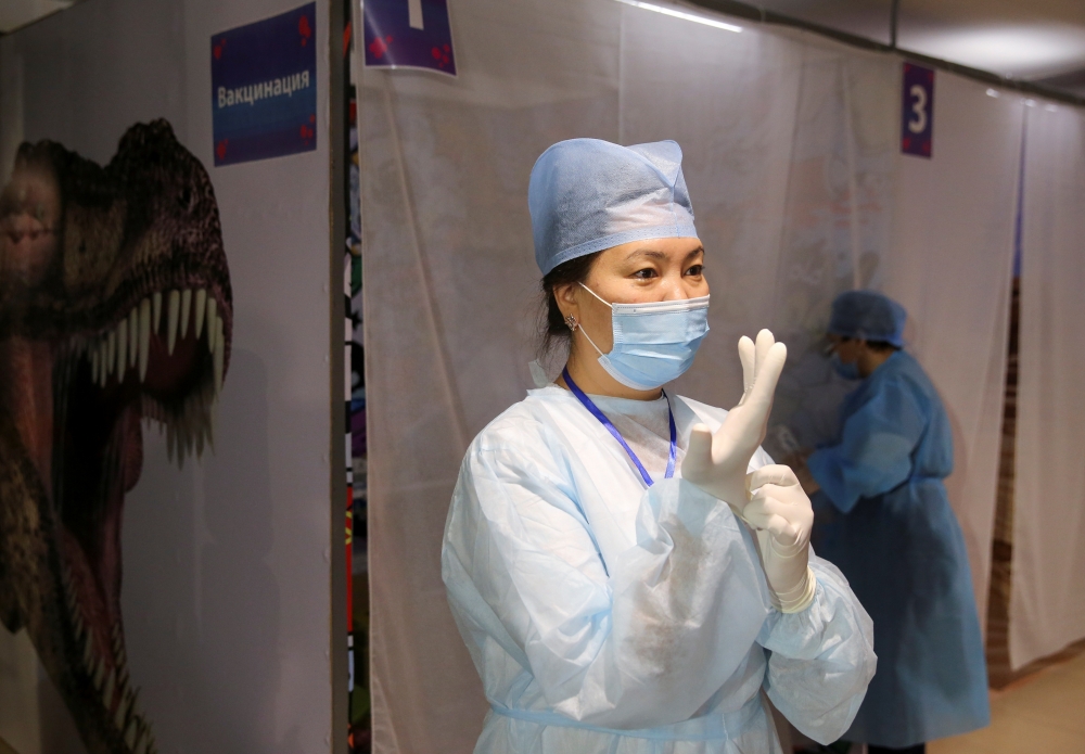 Medical workers are seen in a vaccination centre located at a shopping and entertainment mall in Almaty, Kazakhstan April 27, 2021. Kazakhstan started using its own domestically-developed QazCovid-in vaccine against the coronavirus disease (COVID-19) for 