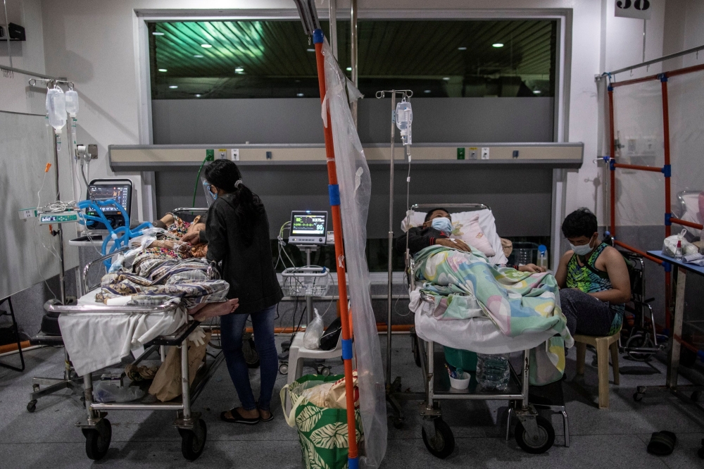 Patients are watched over by relatives and hospital aides inside the COVID-19 emergency room of the government hospital National Kidney and Transplant Institute, which has declared overcapacity amid rising coronavirus disease (COVID-19) infections in Quez