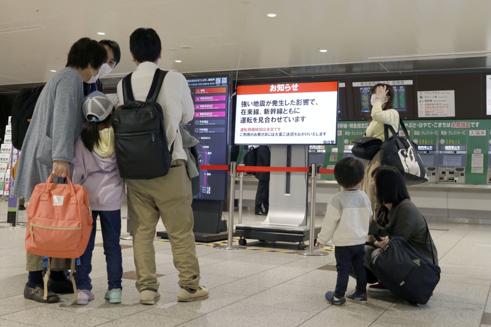 People gather around a ticket gate as train services are suspended following an earthquake in Sendai, Miyagi prefecture, Japan in this photo taken by Kyodo on May 1, 2021. Kyodo/via Reuters