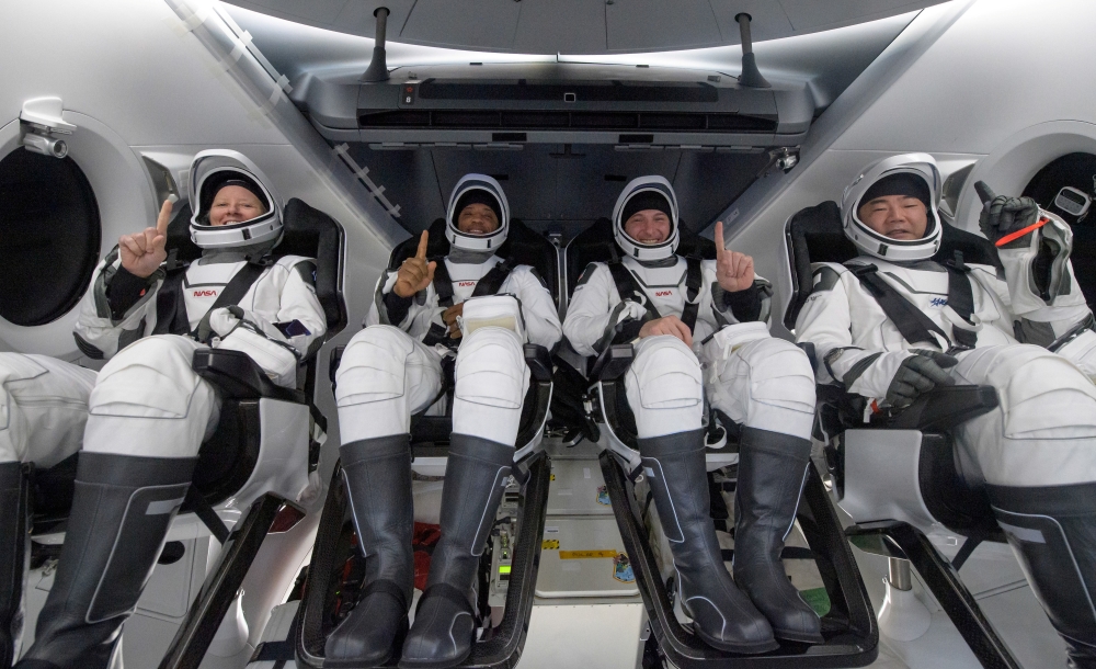 NASA astronauts Shannon Walker, left, Victor Glover, Mike Hopkins, and Japan Aerospace Exploration Agency (JAXA) astronaut Soichi Noguchi react inside the SpaceX Crew Dragon Resilience spacecraft onboard the SpaceX GO Navigator recovery ship shortly after