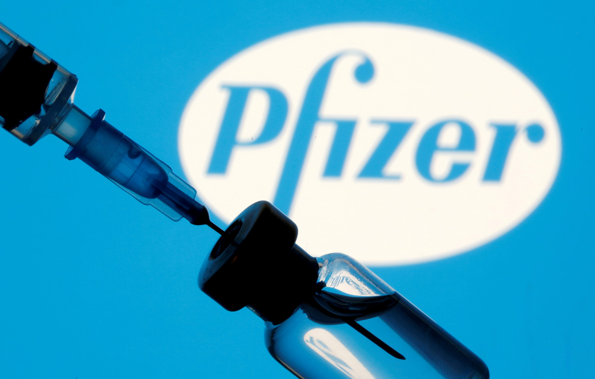 FILE PHOTO: A vial and sryinge are seen in front of a displayed Pfizer logo in this illustration taken January 11, 2021. REUTERS/Dado Ruvic/Illustration/File Photo
