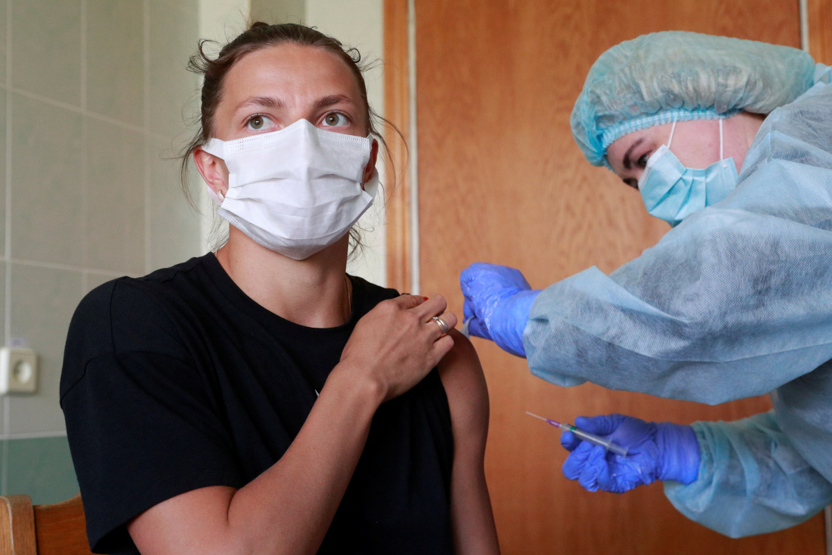 Maryna Bekh-Romanchuk, a long jumper of the Ukrainian Olympic team that will compete in the Tokyo 2020 Olympics, receives a dose of the Chinese-developed CoronaVac vaccine against the coronavirus disease (COVID-19) in Kyiv, Ukraine April 30, 2021. REUTERS