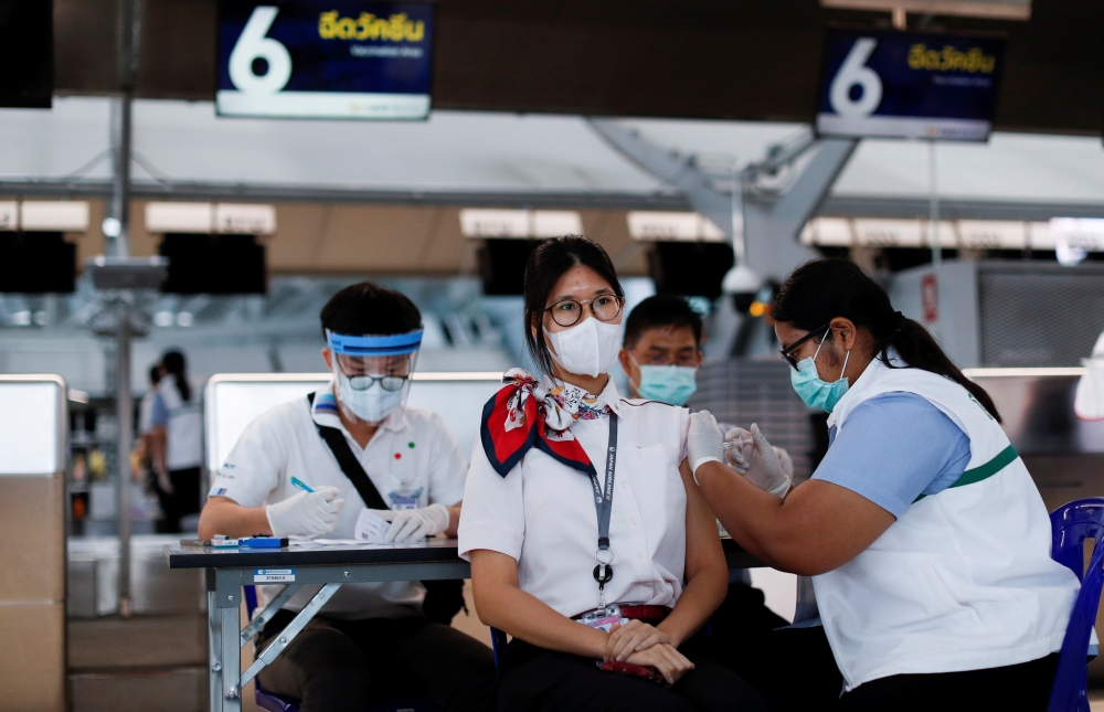 People get vaccinated against the coronavirus disease (COVID-19) at Suvarnabhumi airport in Bangkok, Thailand April 28, 2021. REUTERS/Jorge Silva/File Photo