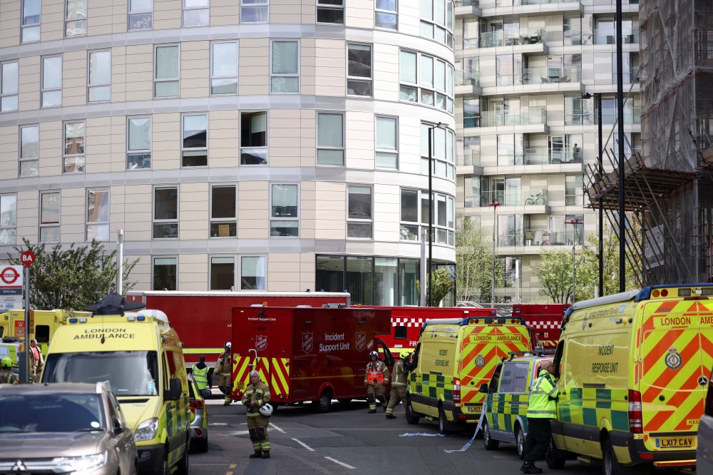 Vehicles of incident response unit are seen outside a damaged residential building in East London, Britain, May 7, 2021. REUTERS/Henry Nicholls