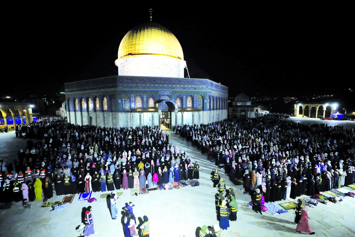 Palestinians pray in front of the Dome of the Rock at the Al Aqsa Mosque compound on Laylat Al Qadr during the holy month of Ramadan, in Jerusalem’s Old City, yesterday. 