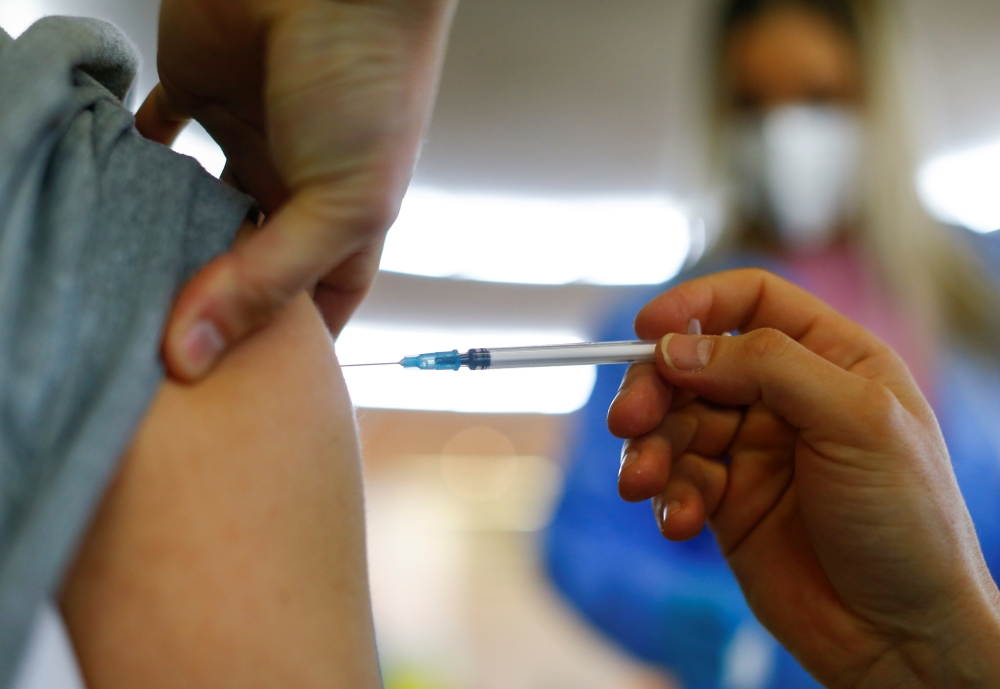 A person receives a dose of the Pfizer-BioNTech COVID-19 vaccine in the Central Mosque in Ehrenfeld suburb, amid the coronavirus disease (COVID-19) pandemic, in Cologne, Germany, May 8, 2021. Reuters/Thilo Schmuelgen