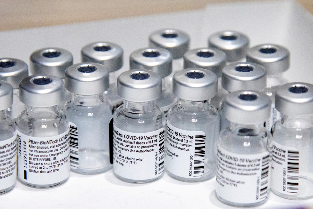 Empty vials of the Pfizer-BioNTech coronavirus disease (COVID-19) vaccine are seen at The Michener Institute, in Toronto, Canada January 4, 2021. REUTERS/Carlos Osorio/File Photo
