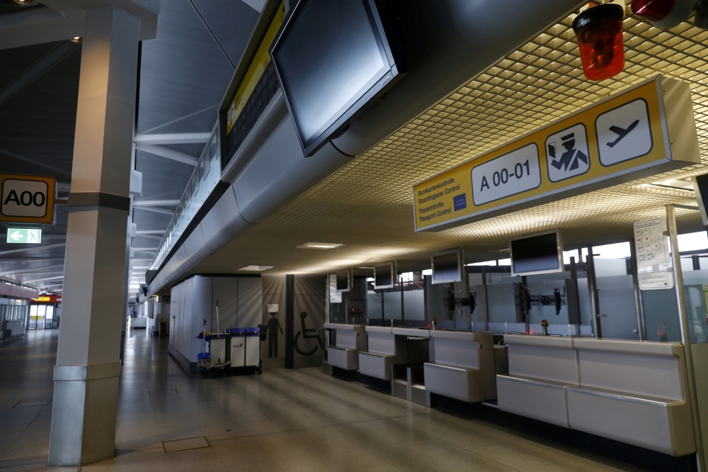 FILE PHOTO: Former check-in desks are seen during the media tour at the former Berlin Tegel airport during the last day before the end of operation in Berlin, Germany, May 4, 2021. REUTERS/Michele Tantussi