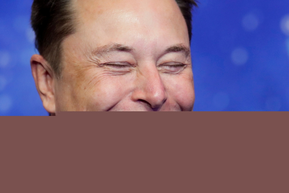 File photo: SpaceX owner and Tesla CEO Elon Musk laughs after arriving on the red carpet for the Axel Springer award, in Berlin, Germany, December 1, 2020. Reuters/Hannibal Hanschke/Pool/File Photo