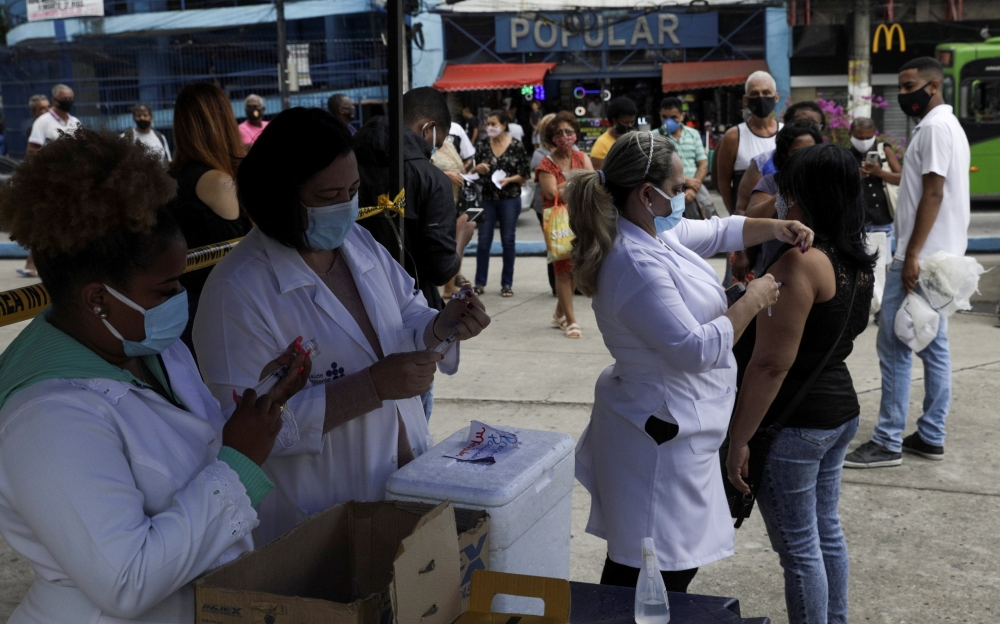 File photo: A citizen receives a dose of the AstraZeneca coronavirus disease (COVID-19) vaccine, during a vaccination day for 57-year-old and older citizens, in Duque de Caxias near Rio de Janeiro, Brazil April 21, 2021. Reuters/Ricardo Moraes/File Photo