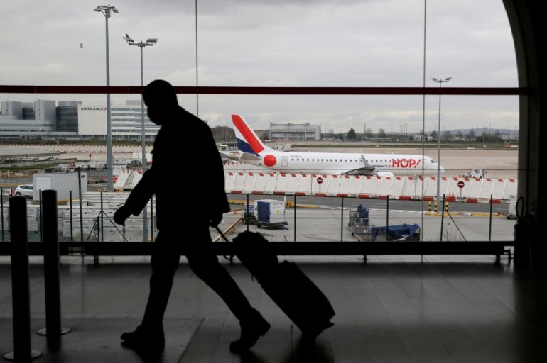 FILE PHOTO: A man walks through a terminal at Paris Charles de Gaulle airport near Paris, February 5, 2021. REUTERS/Gonzalo Fuentes/File Photo
