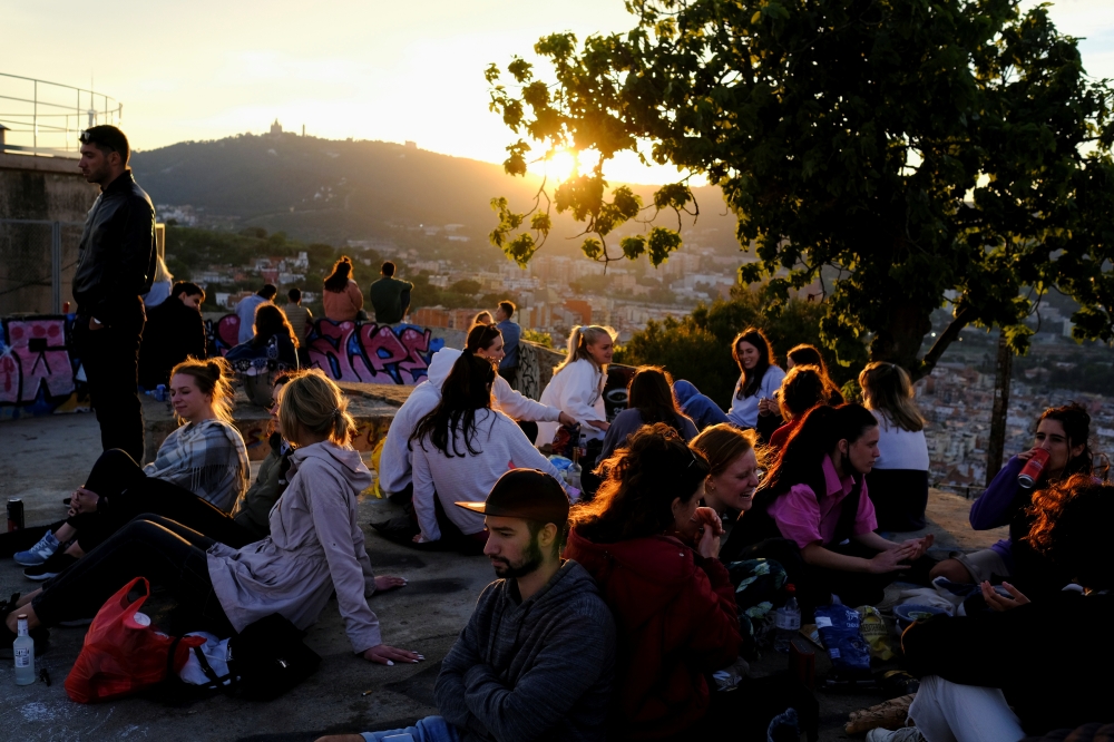 People gather at a lookout point, with a view of the city of Barcelona in the background, as the state of emergency decreed by the Spanish Government to prevent the spread of the coronavirus disease (COVID-19) is due to end on Sunday, in Barcelona, Spain,