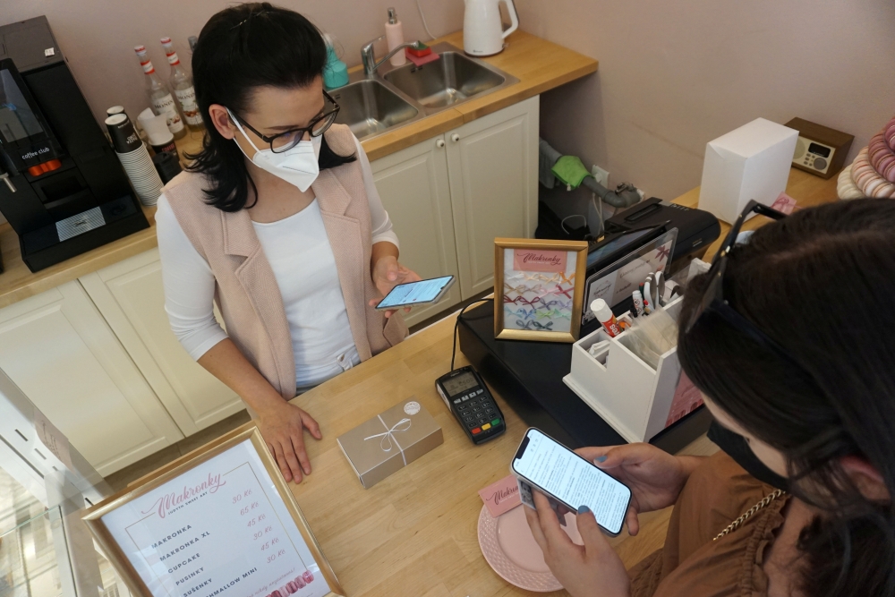 Candy store owner Jitka Hornakova receives Corrency (covid currency) payment through a mobile application, amid the coronavirus disease (COVID-19) pandemic, in Kyjov, Czech Republic, May 12, 2021. Picture taken May 12, 2021. REUTERS/Jiri Skacel