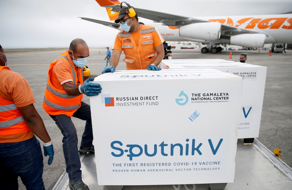 FILE PHOTO: Workers take care of the shipment of Russia's Sputnik V vaccine against the coronavirus disease (COVID-19) at the airport, in Caracas, Venezuela March 29, 2021. REUTERS/Manaure Quintero