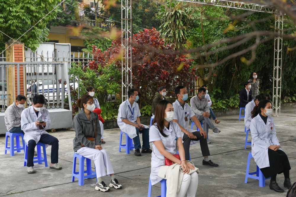 Health workers wait for their turn as Vietnam starts its official rollout of AstraZeneca's coronavirus disease (COVID-19) vaccine for health workers, at Hai Duong Hospital for Tropical Diseases, Hai Duong province, Vietnam. (REUTERS/Thanh Hue/File Photo)