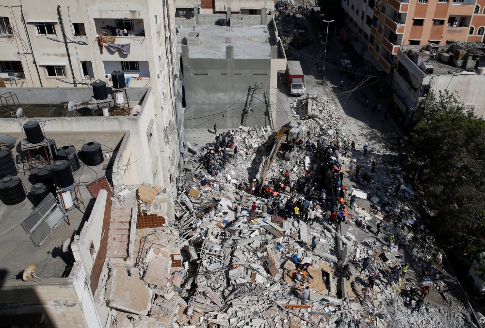 A general view as rescue workers search for victims amid rubble at the site of Israeli air strikes, in Gaza City May 16, 2021. REUTERS/Mohammed Salem