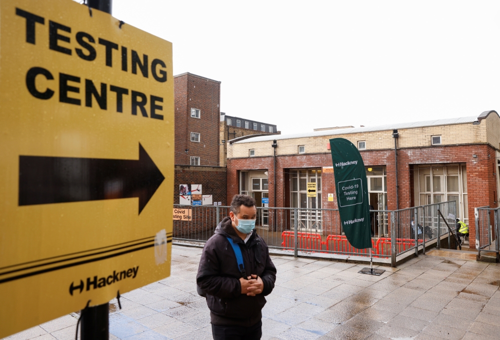 A man wearing a protective mask walks past a testing centre amid the outbreak of coronavirus disease in the Shoreditch area of London, Britain, May 17, 2021. Reuters/John Sibley