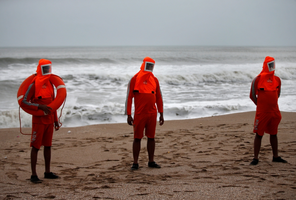 Members of the National Disaster Response Force (NDRF) stand guard along a shore ahead of Cyclone Tauktae in Veraval in the western state of Gujarat, India, May 17, 2021. Reuters/Amit Dave
